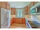 Well-lit kitchen featuring wood cabinets, granite countertops, and stainless steel appliances at 17 Johnson Rd, Charleston, SC 29407