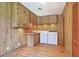 Cozy laundry room features a washer, dryer, sink, wooden cabinets, and hardwood floors at 17 Johnson Rd, Charleston, SC 29407