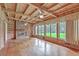Cozy living room with a brick fireplace, wooden paneled walls, and abundant natural light at 17 Johnson Rd, Charleston, SC 29407