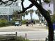 Golf carts and people parked at a beach access point near residential homes on a sunny day at 1736 E Ashley Ave, Folly Beach, SC 29439