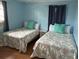 Bedroom featuring two twin beds, each with a coral-themed patterned comforter at 1736 E Ashley Ave, Folly Beach, SC 29439