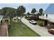 Driveway and exterior features with a combination of natural beauty with palm trees and manicured landscaping at 1736 E Ashley Ave, Folly Beach, SC 29439