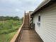 Wooden deck with exterior stairs and scenic views of the surrounding nature at 1736 E Ashley Ave, Folly Beach, SC 29439