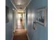 Inviting hallway featuring beautiful wood floors and calming blue walls at 1736 E Ashley Ave, Folly Beach, SC 29439