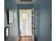 Hallway with blue paneling leading to a room with lots of natural light at 1736 E Ashley Ave, Folly Beach, SC 29439