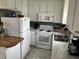 Bright kitchen with white appliances, marble countertops and stainless steel sink at 1736 E Ashley Ave, Folly Beach, SC 29439