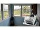 Laundry room with large windows offering views of a lighthouse and palm trees at 1736 E Ashley Ave, Folly Beach, SC 29439