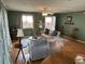 Comfortable living room with neutral furniture, hardwood floors, TV, and access to outdoor spaces at 1736 E Ashley Ave, Folly Beach, SC 29439