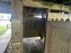 An outdoor shower features a wooden structure with a door for privacy, offering a refreshing rinse at 1736 E Ashley Ave, Folly Beach, SC 29439