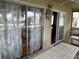 Enclosed porch with sliding doors and white wood flooring overlooking backyard at 1736 E Ashley Ave, Folly Beach, SC 29439