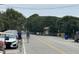 A street scene shows people walking towards a beach access point on a sunny day at 1736 E Ashley Ave, Folly Beach, SC 29439