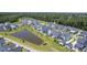 Overhead view of houses nestled around a pond, bordered by dense, green woods at 1787 Timmons St, Mount Pleasant, SC 29466