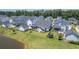 Charming aerial view of single-Gathering houses next to a relaxing pond with lush green lawns at 1787 Timmons St, Mount Pleasant, SC 29466