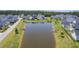 A tranquil pond surrounded by lush greenery complements the nearby lovely single-Gathering homes in this aerial scene at 1787 Timmons St, Mount Pleasant, SC 29466