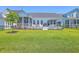 Grassy backyard features a covered porch, patio, and entertainment area at 1787 Timmons St, Mount Pleasant, SC 29466