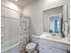 Bathroom with a shower-tub combo and a vanity with drawers and cabinets for storage at 1787 Timmons St, Mount Pleasant, SC 29466