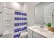 Well-lit bathroom with a shower, vanity, mirror, and blue striped shower curtain at 1787 Timmons St, Mount Pleasant, SC 29466