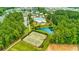 Aerial view of a neighborhood with a community pool, pond, and tennis courts surrounded by trees at 1787 Timmons St, Mount Pleasant, SC 29466