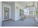 Inviting front porch with comfortable rocking chairs, ceiling fan, and a beautifully decorated front door at 1787 Timmons St, Mount Pleasant, SC 29466