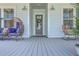Relaxing front porch seating area with comfortable chairs, decorative wreath, and stylish outdoor decor at 1787 Timmons St, Mount Pleasant, SC 29466