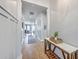 Long, bright hallway with beautiful hardwood floors and stylish wainscoting leading to the living area at 1787 Timmons St, Mount Pleasant, SC 29466