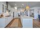 Well-lit kitchen boasts an island, white cabinetry, and stainless steel appliances at 1787 Timmons St, Mount Pleasant, SC 29466