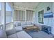 Relaxing screened porch features modern furniture, a TV, and a cozy electric fireplace at 1787 Timmons St, Mount Pleasant, SC 29466