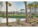 Scenic tennis courts surrounded by palm trees and tranquil water feature, providing a beautiful recreational space at 1787 Timmons St, Mount Pleasant, SC 29466