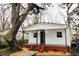 Charming home with a welcoming front porch, brick foundation and a mature tree at 1925 Kerry St, North Charleston, SC 29406