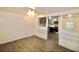 Bright living room with wood-look floors and white walls leading to the kitchen at 1925 Kerry St, North Charleston, SC 29406