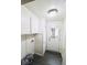 Mud room with overhead cabinets, white wainscoting and a door to the backyard at 1925 Kerry St, North Charleston, SC 29406