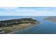 Gorgeous aerial view of waterfront homes, private docks, and coastline under a blue sky at 2 Mcdonough Rd # B-11, Folly Beach, SC 29439