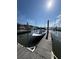 Boat docked near a pier with surrounding water and waterfront building in the background at 2 Mcdonough Rd # B-11, Folly Beach, SC 29439