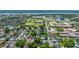 High-angle aerial view captures a residential area with trees and houses, along with a school and recreational field at 200 Fishburne St, Charleston, SC 29403