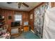 Bedroom features paneled walls, ceiling fan, television, and a window with blinds at 200 Fishburne St, Charleston, SC 29403