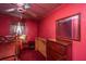 Red painted bedroom features a bed, red carpet, and antique dresser at 200 Fishburne St, Charleston, SC 29403