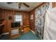 Bedroom features paneled walls, a ceiling fan, television, and a window with blinds at 200 Fishburne St, Charleston, SC 29403