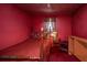Cozy bedroom features a four-poster bed, lamp, and red carpet at 200 Fishburne St, Charleston, SC 29403
