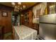 Traditional dining room with wood paneling, chandelier, and Galanz refrigerator at 200 Fishburne St, Charleston, SC 29403