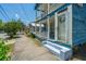 Charming blue two-story home with double balconies, detailed trim, and inviting front steps at 200 Fishburne St, Charleston, SC 29403