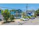 Charming blue two-story home with double balconies and a well-maintained front yard in a neighborhood setting at 200 Fishburne St, Charleston, SC 29403