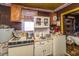 Vintage kitchen with dated cabinets, stove, and adjacent dining area at 200 Fishburne St, Charleston, SC 29403
