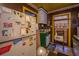 Dated kitchen with green cabinets, linoleum floors, and cluttered decor at 200 Fishburne St, Charleston, SC 29403