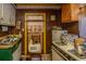 Small kitchen area with a sink, microwave, and outdated cabinets with yellow trim at 200 Fishburne St, Charleston, SC 29403