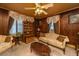 Living room featuring wood walls, vintage furniture, and elegant decor, offering a cozy and inviting space at 200 Fishburne St, Charleston, SC 29403