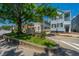 A charming street scene with historic homes, mature trees, and a welcoming neighborhood sign at 200 Fishburne St, Charleston, SC 29403