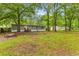 Charming single-story home with a lush green lawn and mature trees at 201 Frank St, Summerville, SC 29483