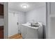 Bright laundry room featuring a washer, dryer, and utility door, perfect for convenient chore management at 201 Frank St, Summerville, SC 29483