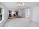 Inviting living room with cozy carpet that blends with a modern kitchen and dining area at 201 Frank St, Summerville, SC 29483