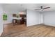 Spacious open-concept living area with laminate flooring, ceiling fan and kitchen area visible at 201 Frank St, Summerville, SC 29483